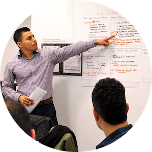 Man pointing to text on a whiteboard.
