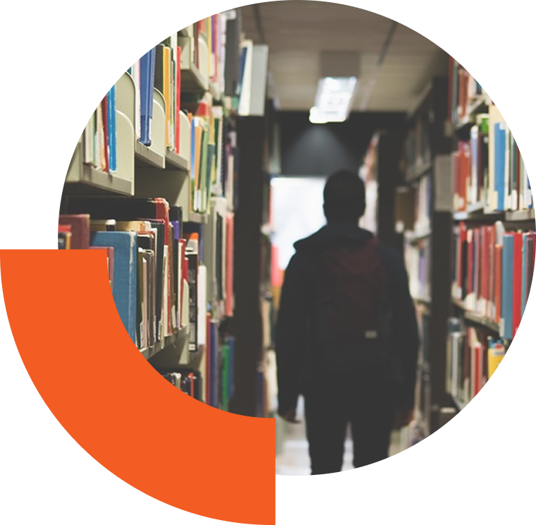 ESK_Resources-Hero Person walking through stacks of books in a library