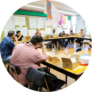 Group of educators seated in a boardroom.