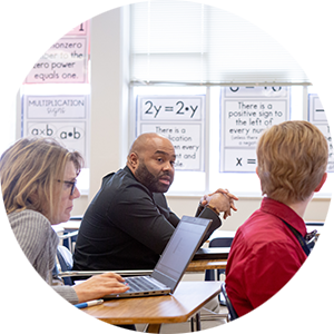 Three educators learning together in a classroom